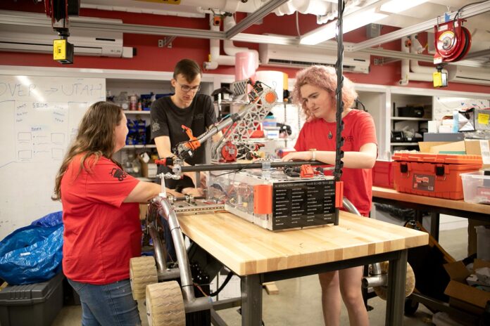 Shannon McInnis, Garrit Strenge, and Brooke Chalmers work on the rover. Photo by Sarah Olender.